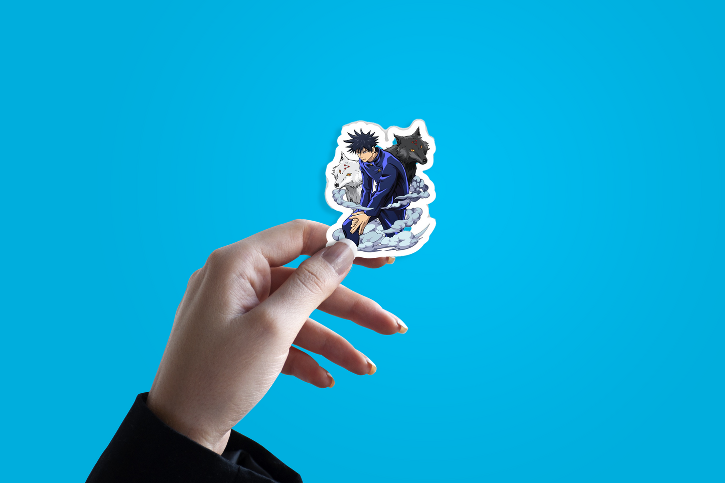 Hand holding a sticker with an anime character against a blue background