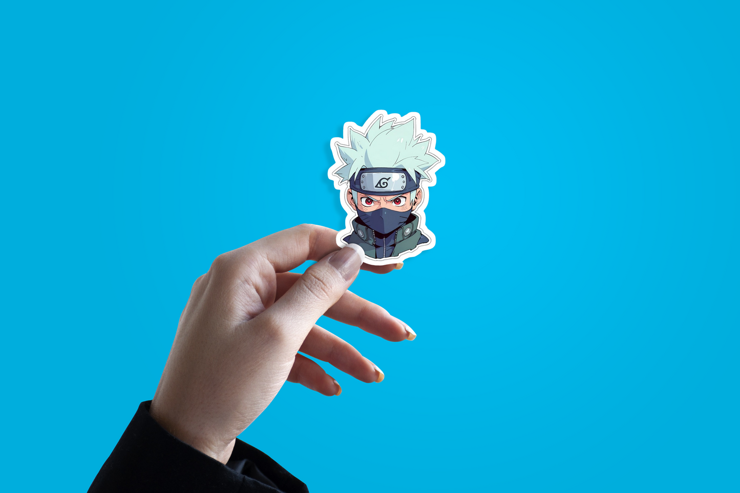 Hand holding a sticker of Itachi Uchiha an anime character from Naruto against a blue background