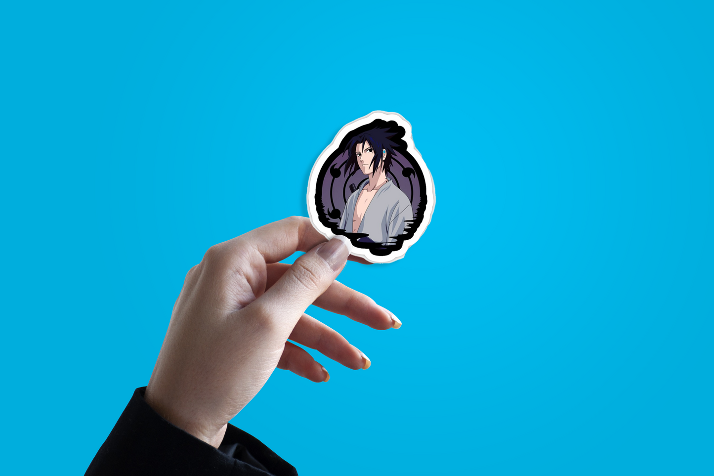 Hand holding a sticker with an anime character against a blue background from Naruto anime Itachi Uchiha