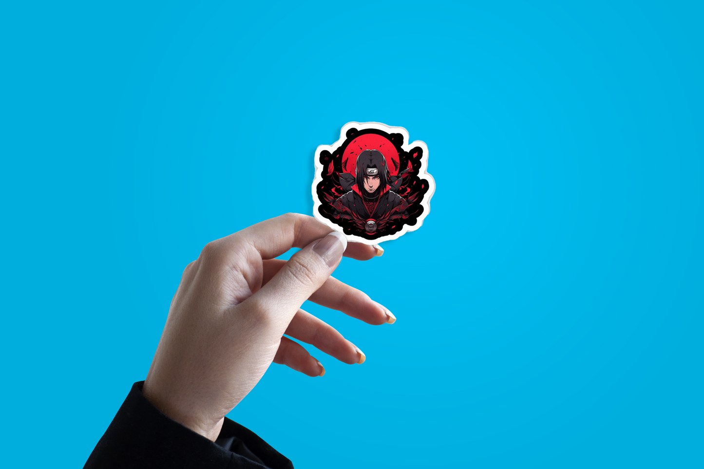 Hand holding a sticker with a red and black design against a blue background